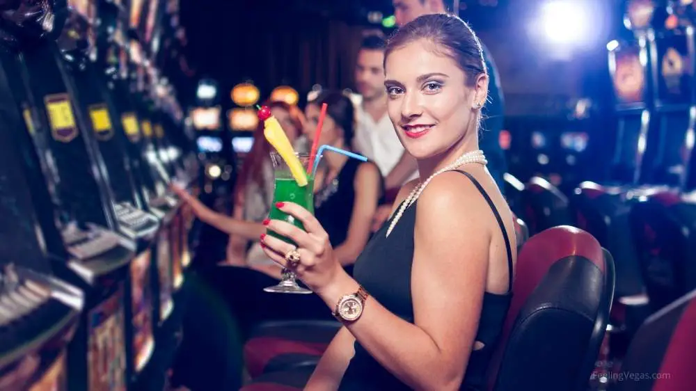 The Cost of a Trip to Las Vegas (Let's Break it Down) 5 Woman with drink in casino: drink costs in Las Vegas