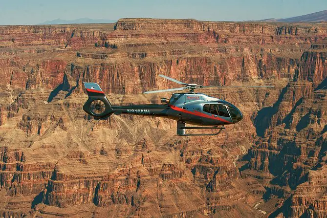 Embark on an Aerial Adventure: The Grand Canyon Deluxe Helicopter Tour from Las Vegas 2 Helicopter flying over the Grand Canyon.