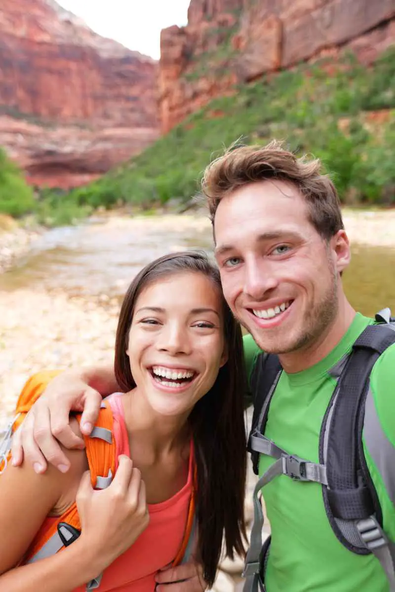 How to See Zion National Park in One Day (Explore!) 2 A young couple hiking in Zion National Park