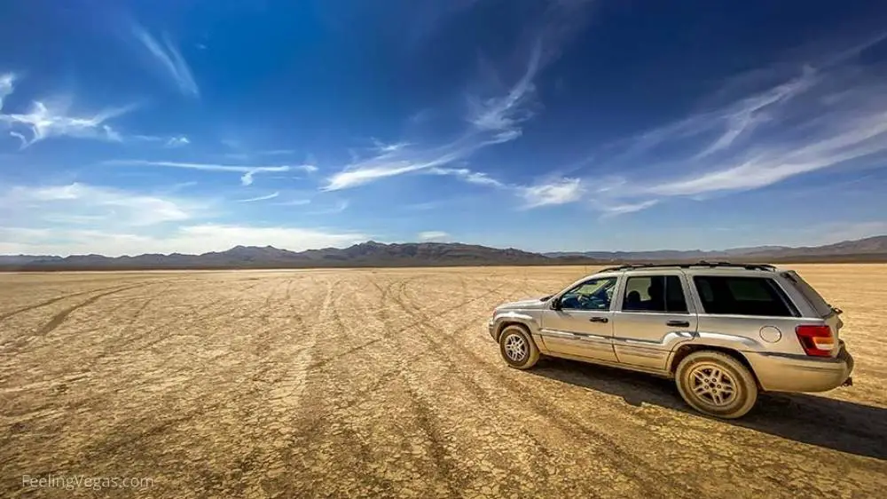 16 Best Day Trips from Las Vegas (Ultimate Guide & Map) 6 An SUV driving at Jean Dry Lake Bed.