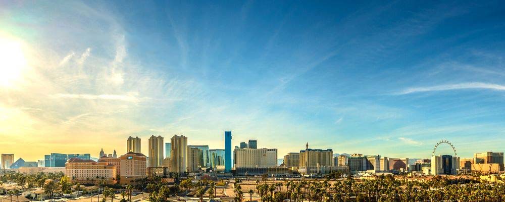 Complete List of Las Vegas Resort Fees by Hotel (2025) 2 Las Vegas resort fees list: Skyline view of the Las Vegas Strip during the day.