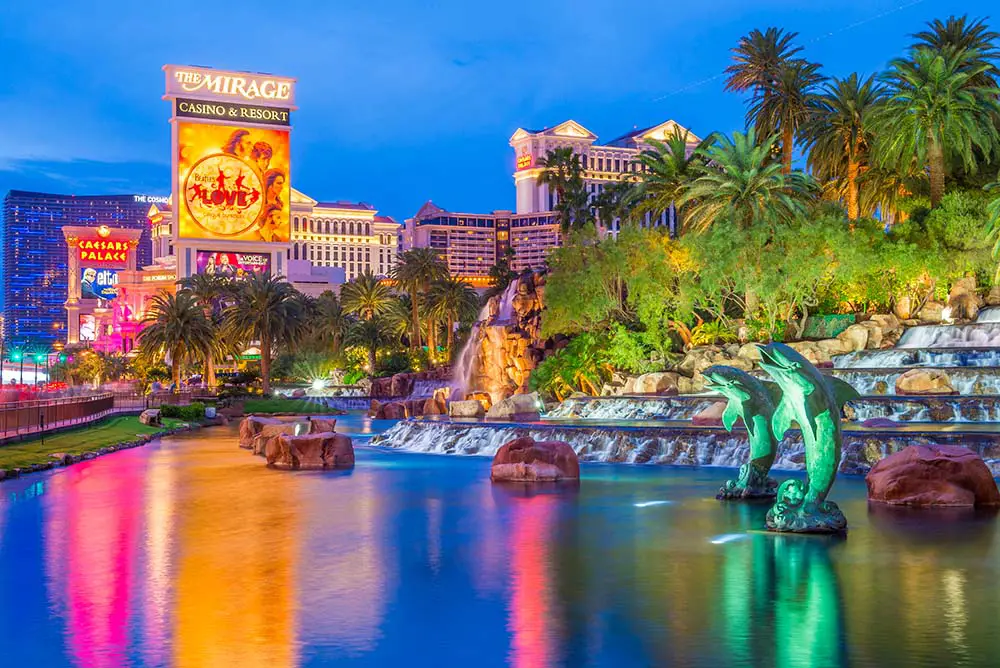 Las Vegas Strip FREE Walking Tour & Map (19 Must-See Stops!) 16 View of the Mirage sign and lake during a walk along the Strip