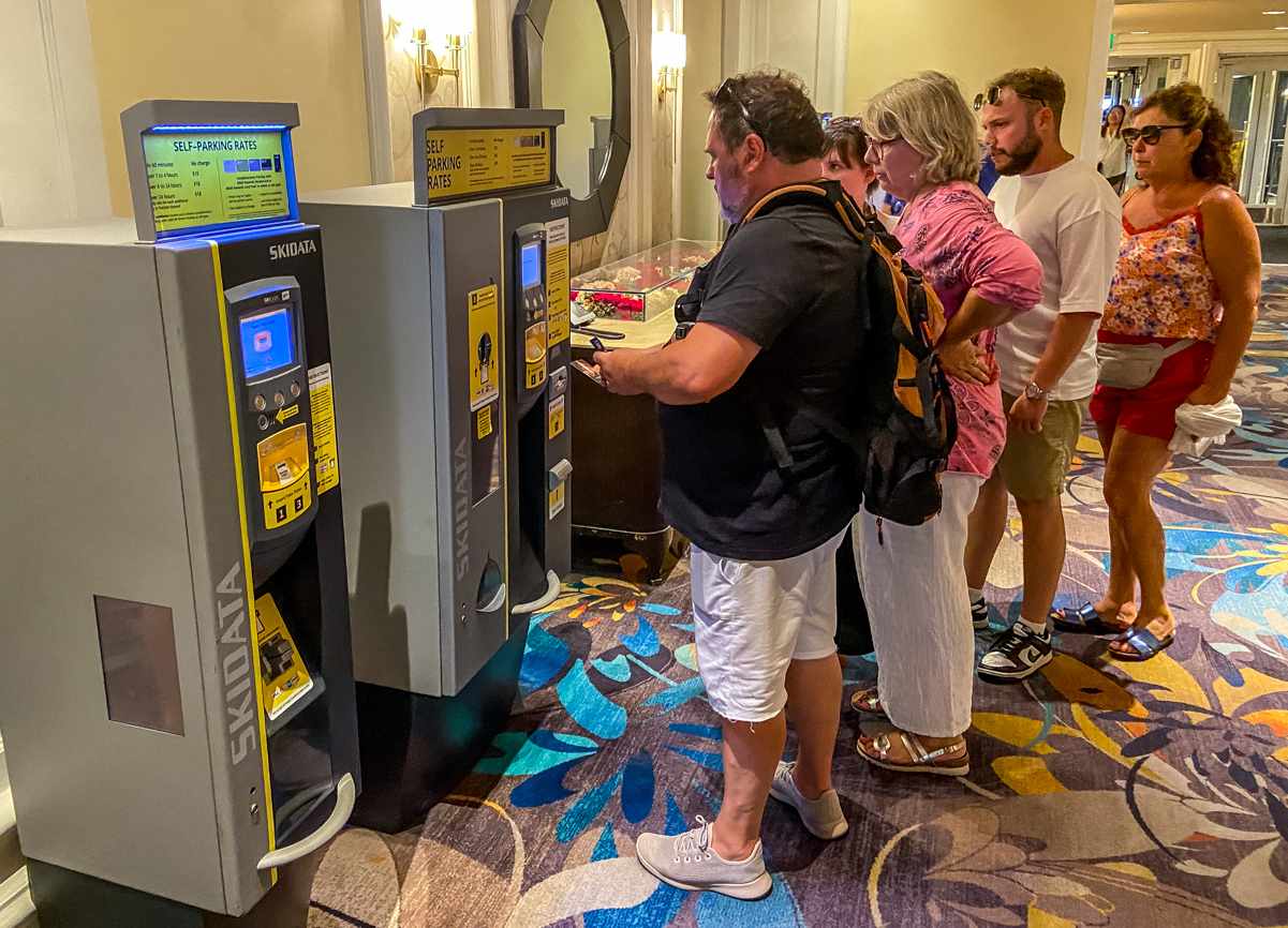 Bellagio Las Vegas Parking Fees in 2023 (Plus Tips & Tricks) 6 guests paying the bellagio parking fee at a kiosk before entering the parking garage