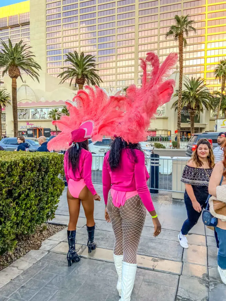 How Much to Tip Vegas Street Performers? (Vegas Tipping) 4 showgirls on the Las Vegas Strip during the day