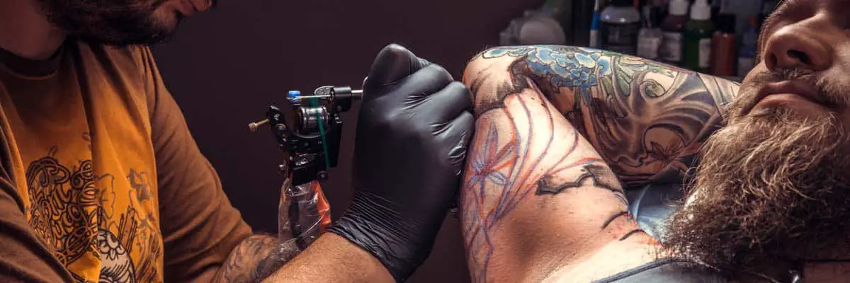 26 Unique Souvenirs from Las Vegas (and Where to Find Them) 18 Club Tattoo in Las Vegas: man getting a tattoo in las vegas