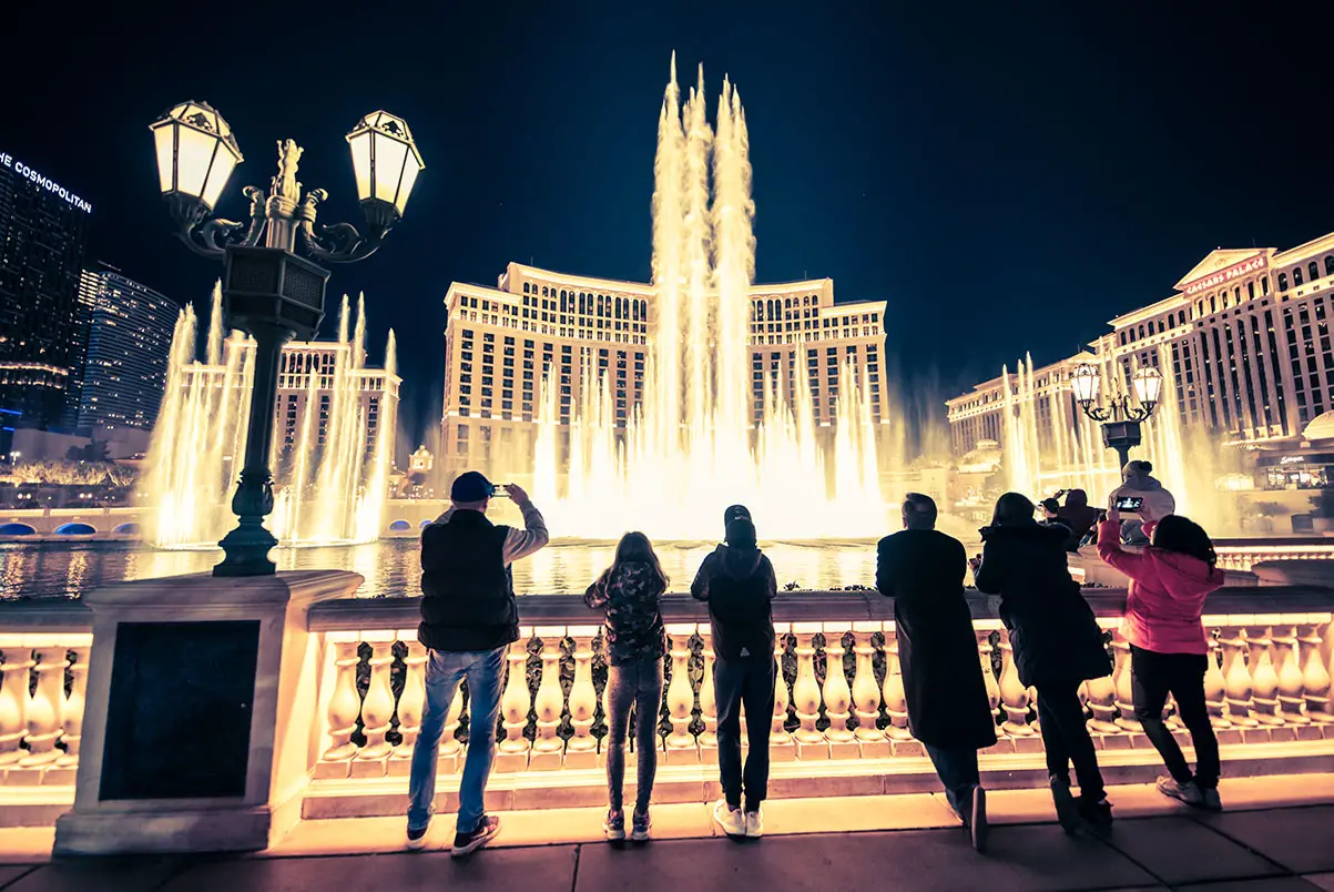 Bellagio Fountain Schedule & Song List (2025 Show Times) 6 Tourists enjoy the Bellagio Fountains on the sidewalk along the Las Vegas Strip.
