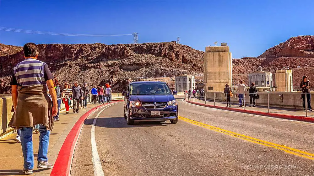Is It Free to Visit the Hoover Dam? (What You Need to Know) 3 Visitors walk and drive across the Hoover Dam